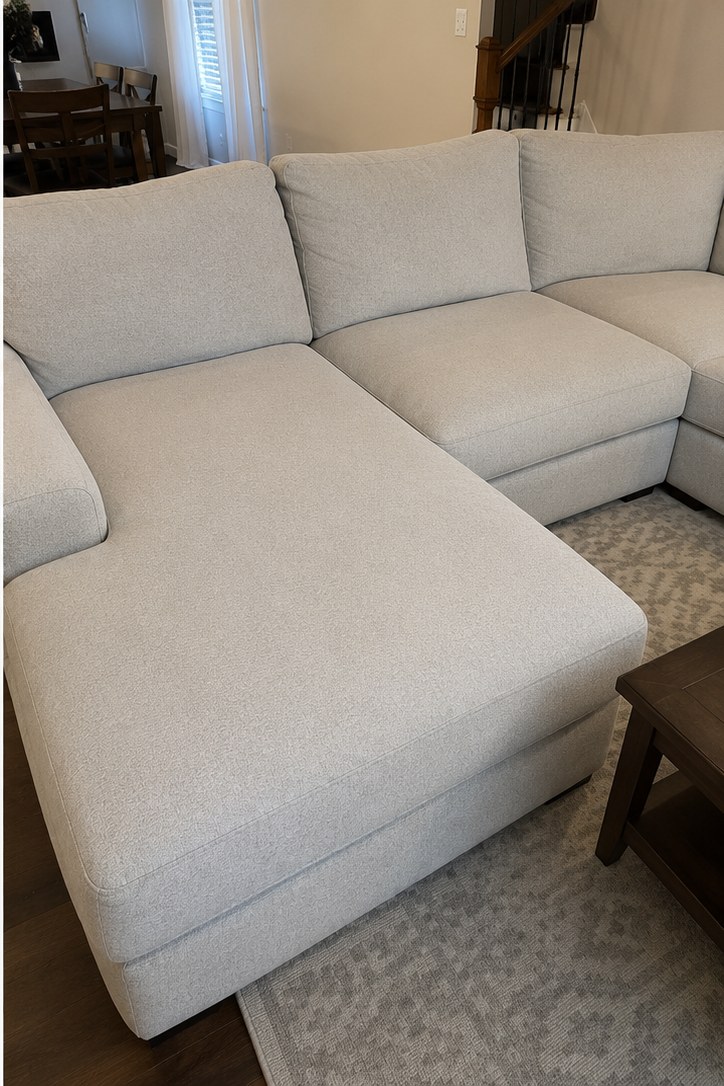 After: Light-gray microfiber sectional in a Rossview home — food and body-oil staining removed with low-moisture upholstery cleaning. Dry to sit on in about 4 hours.